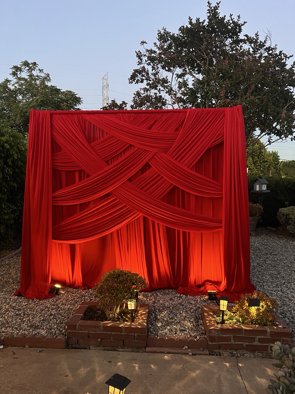 Red draped backdrop with warm uplighting